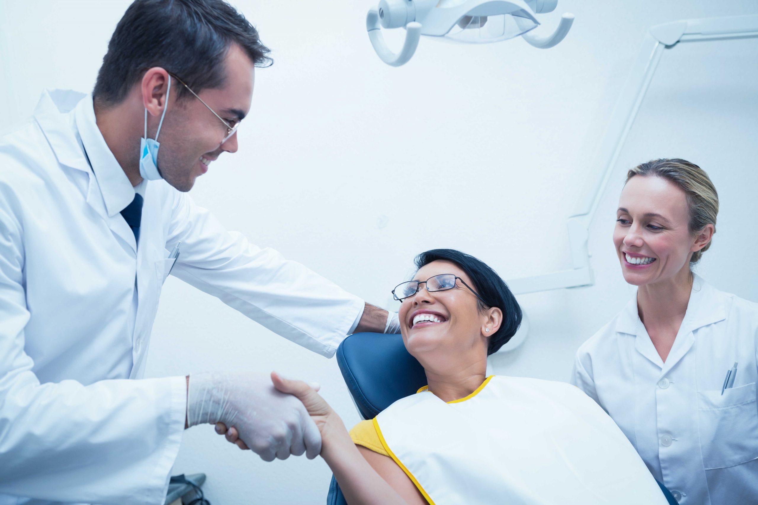 male-dentist-shaking-hands-with-woman-in-the-dentists-chair-in-downers-grove-il.jpg